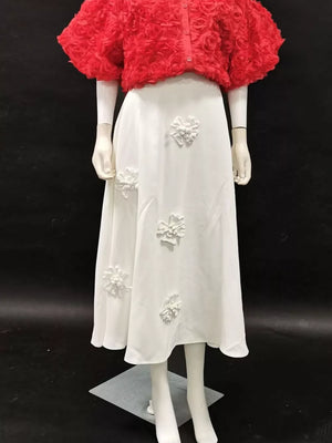 White midi skirt with 3D floral appliqués, paired with a red textured rose print cropped jacket.