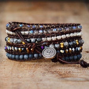 Black wrap-around bracelet with agate and crystal beads, leather cord, and silver button closure.