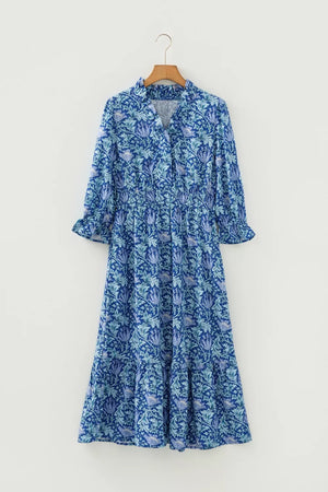 Blue floral cotton midi dress with cinched waist and frilled cuffs.