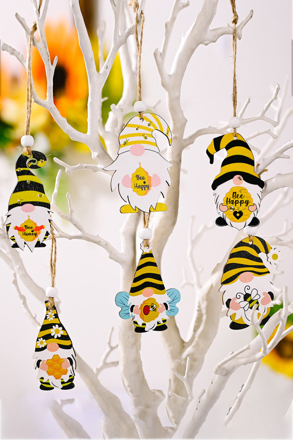 Whimsical bee gnome ornaments in yellow and black stripes with cute bee details.