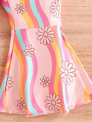 Baby jumpsuit with pink, yellow, blue, and orange wavy stripes and floral print.