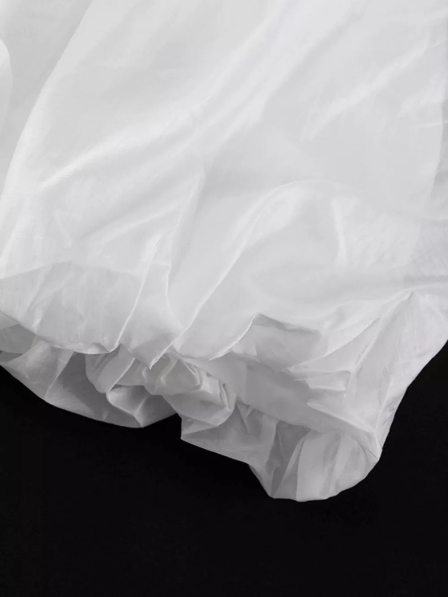 White sheer fabric with ruffled hem detail