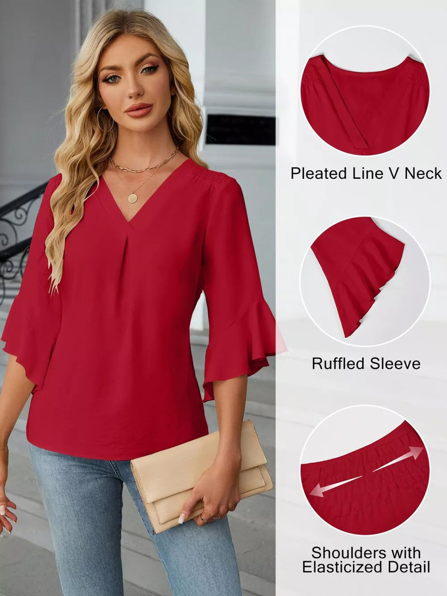 Red V-neck blouse with ruffled sleeves and elasticized shoulders.