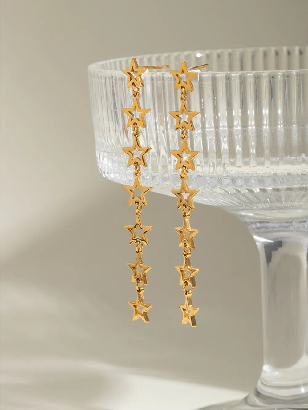 Gold celestial star dangle earrings with multiple stars on chains