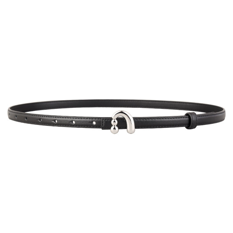 Black skinny leather belt with a silver buckle featuring two small spheres.
