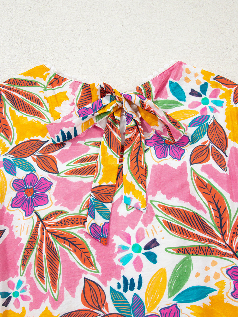 Print bell sleeve mini dress with a colorful floral pattern and tie-neck detail.