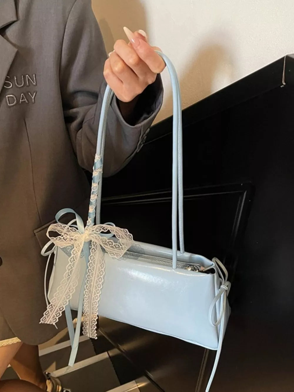 shoulder bag in baby blue featuring lace detail and boxy fit