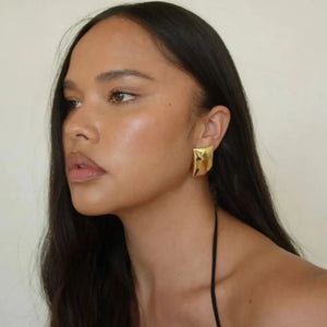 Sculpted gold rectangle earrings with a hammered finish.