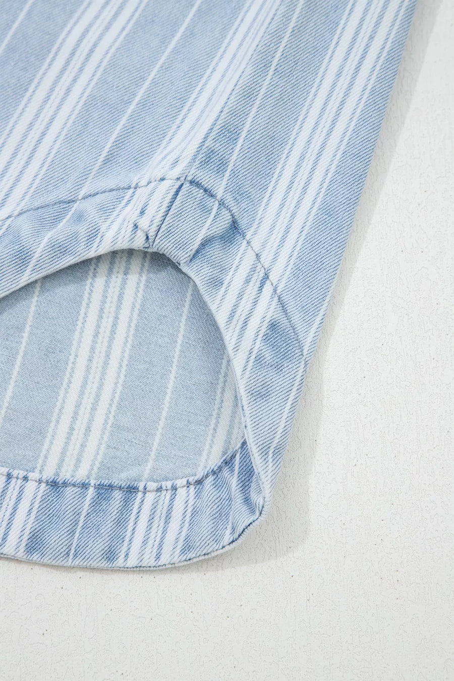 Relaxed stripe denim shacket with pocket detail, light blue and white vertical stripes.