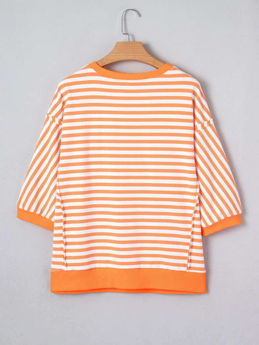 Oversized orange and white striped cotton t-shirt with 3/4 sleeves and crew neck.