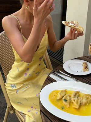 Yellow floral print slip dress with spaghetti straps and a V-neck.