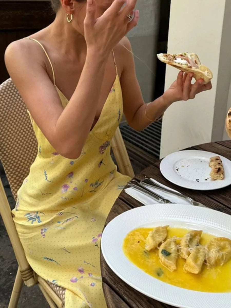 Yellow floral print slip dress with spaghetti straps and a V-neck.