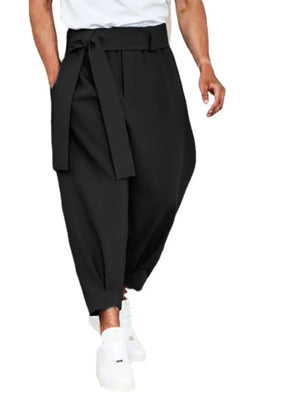 Black balloon-leg wrap trousers with a tie waist and cuffed hem.