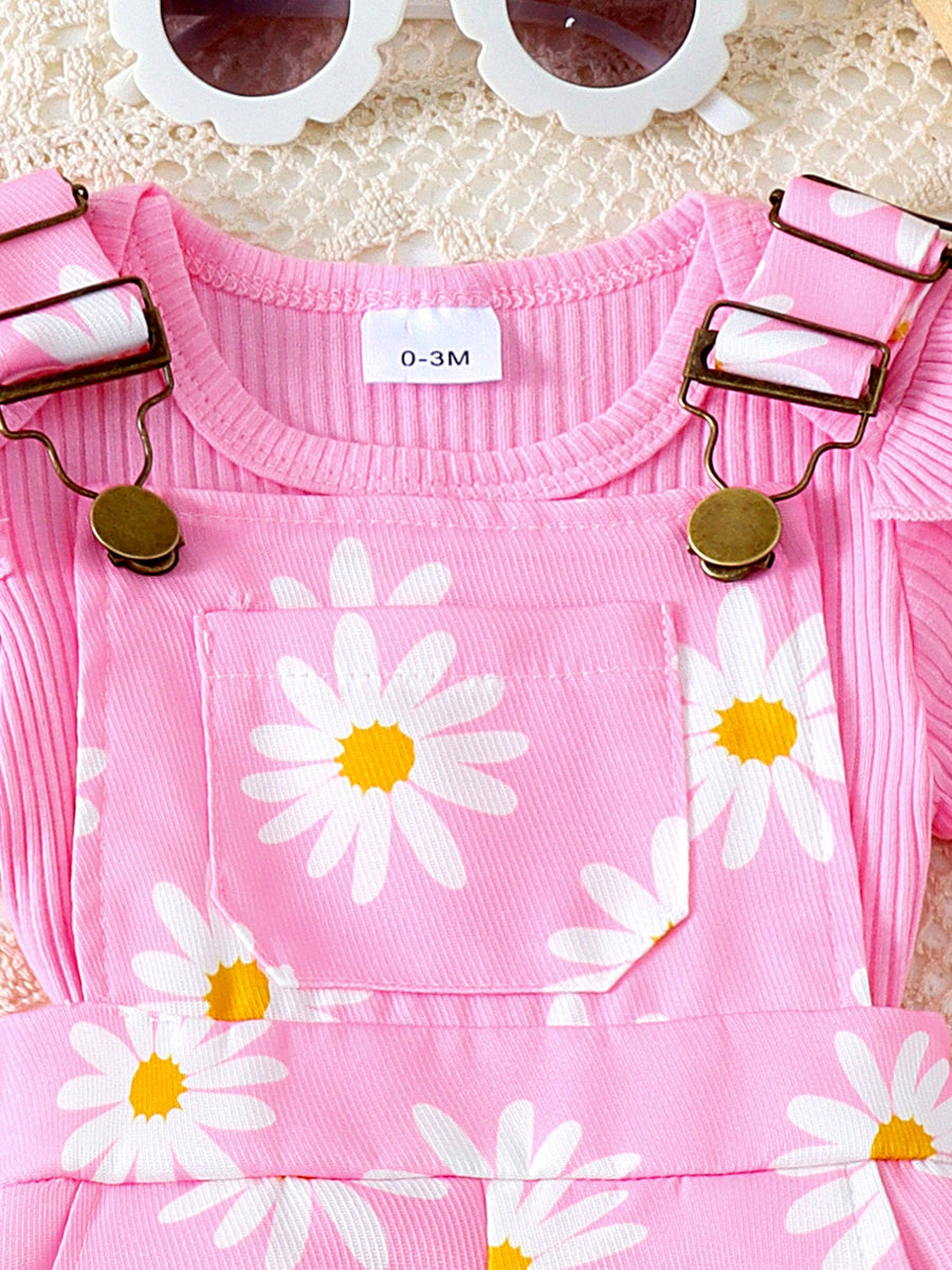 Pink ribbed top and daisy print overalls set with ruffle trim.