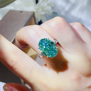 Emerald cut moissanite cocktail ring in turquoise with diamond accents.