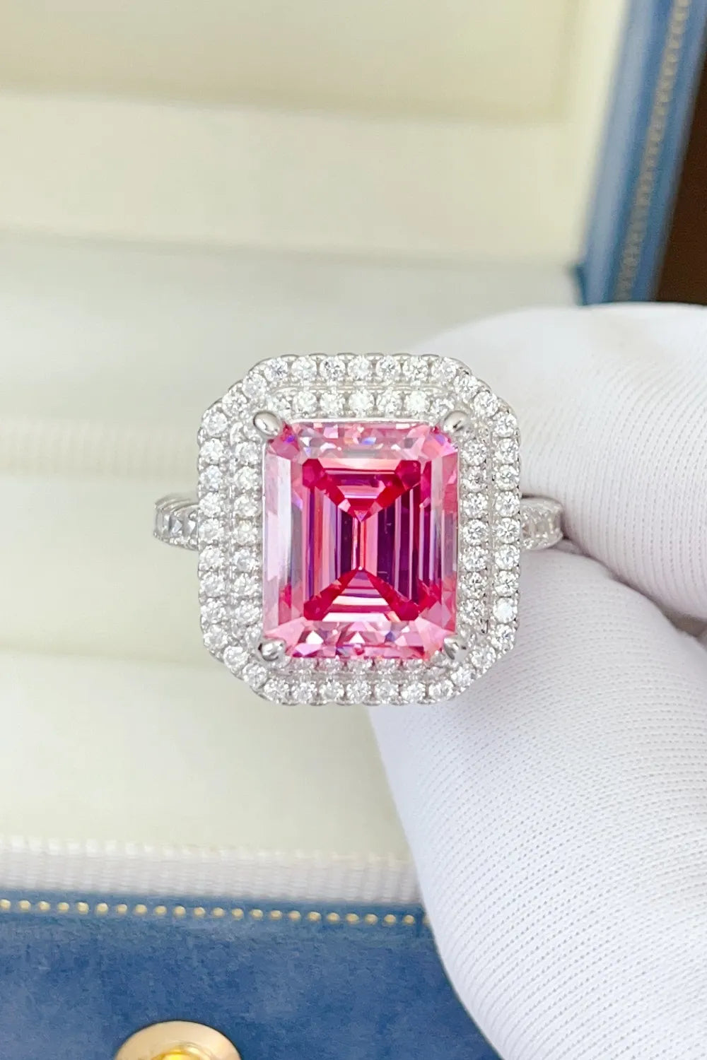 Hot pink emerald cut halo ring with pave diamond band.