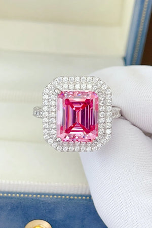 Hot pink emerald cut halo ring with pave diamond band.