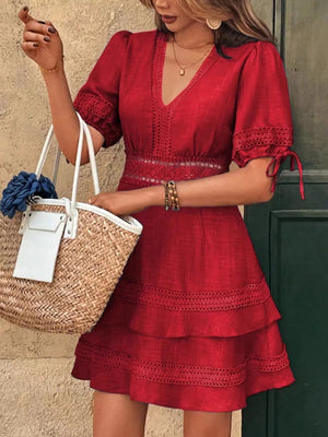Red lace-embellished V-neck mini dress with tiered skirt and puff sleeves.