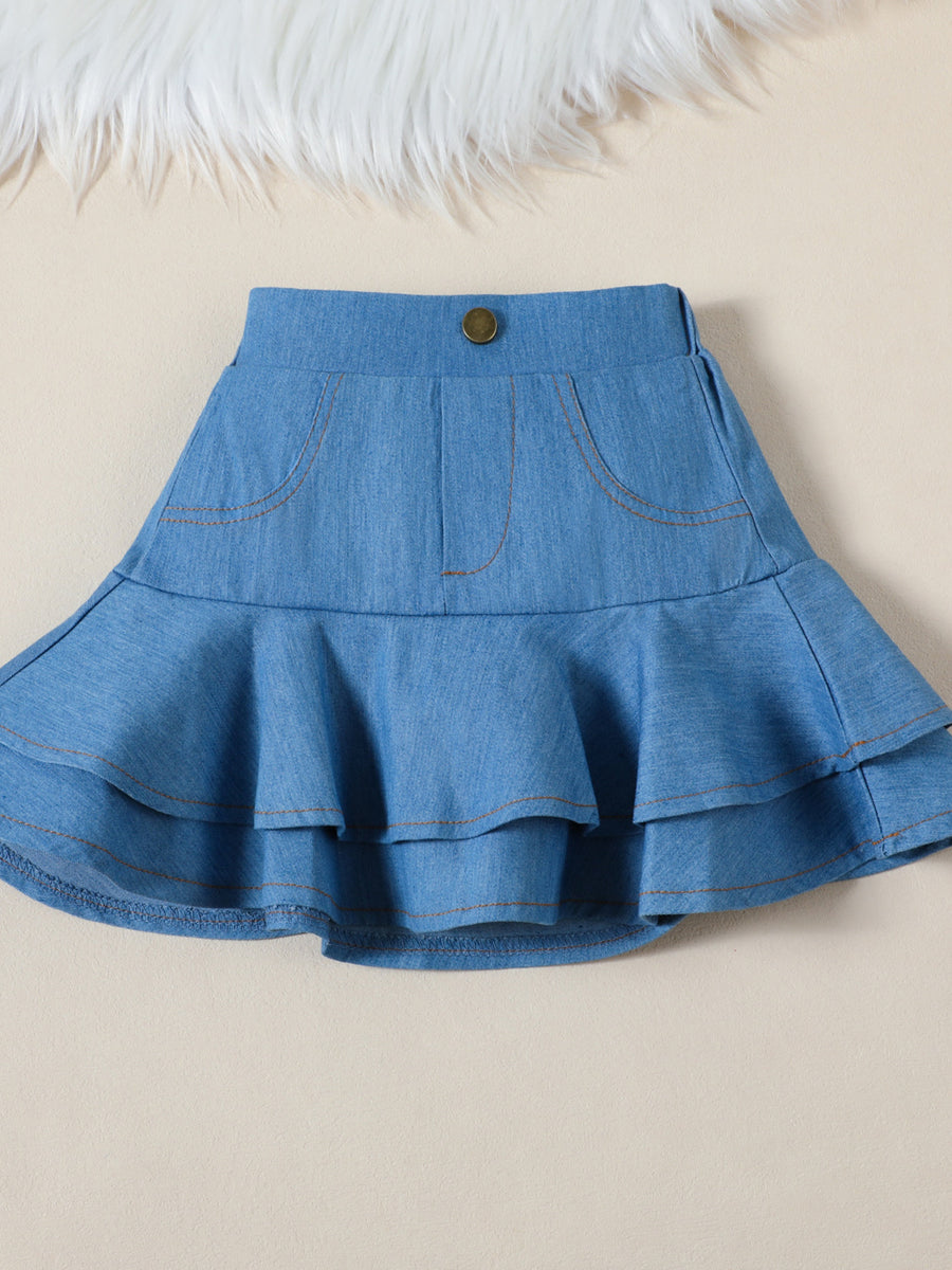 Toddler denim skirt with tiered ruffles and faux pockets.