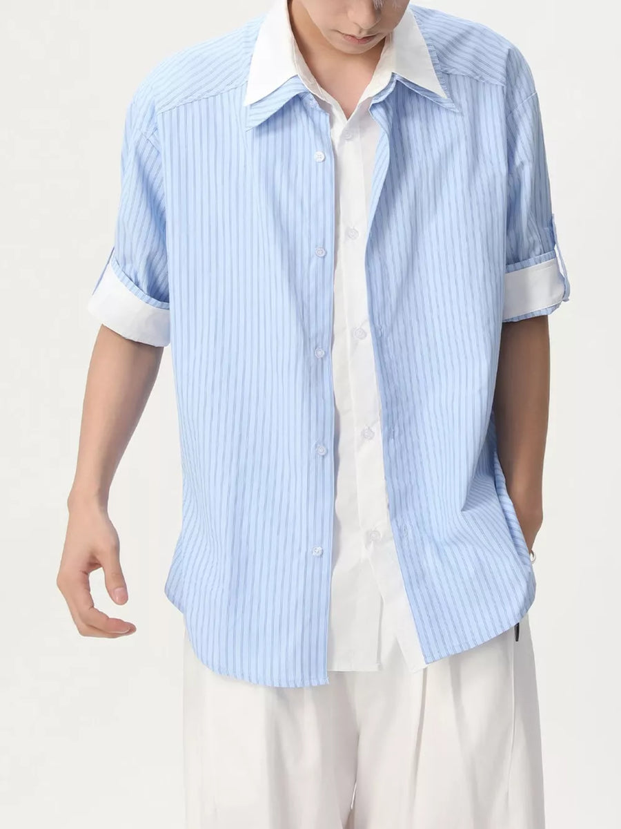 Blue striped casual button-up shirt with rolled sleeves and white undershirt.