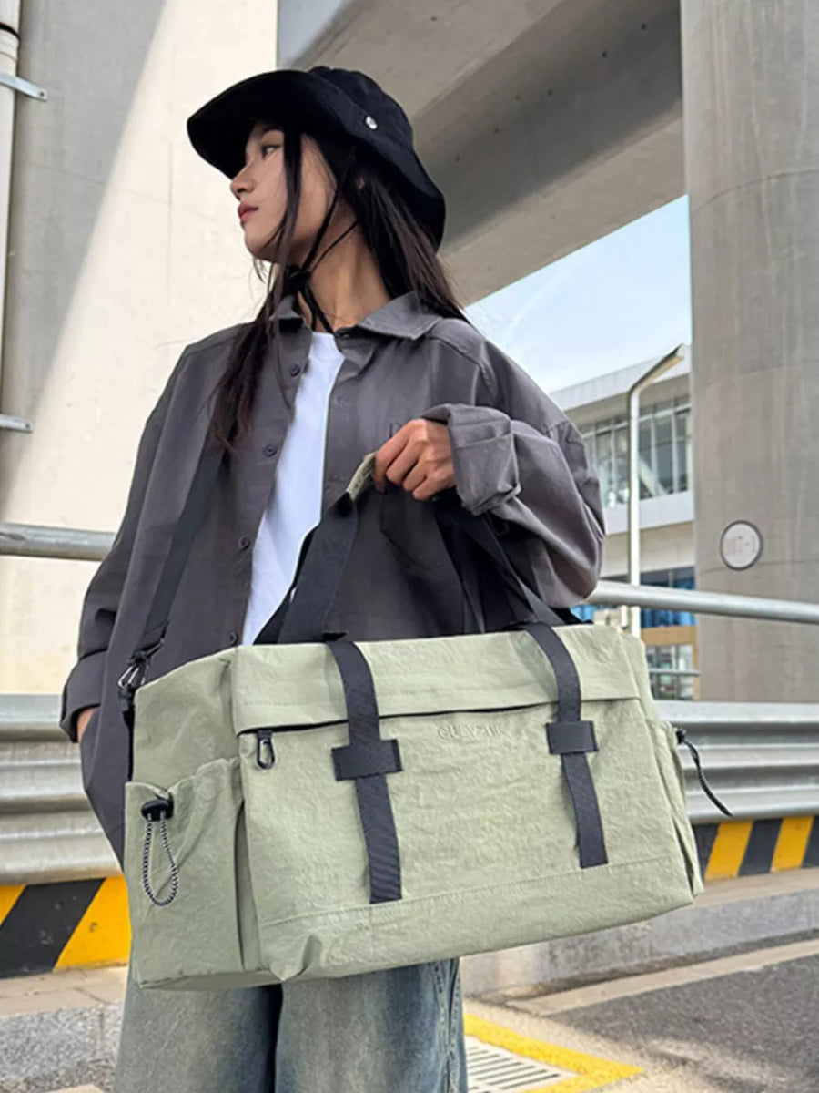 Spacious olive green duffel bag with adjustable strap and side pockets