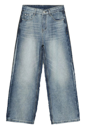 Paneled wide-leg denim trousers in medium wash with a relaxed fit.
