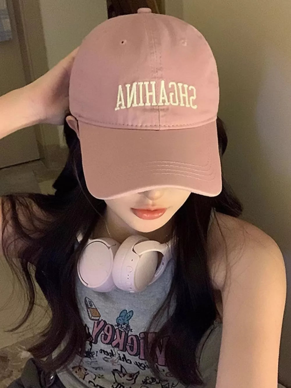 Pink cotton baseball cap with mirrored embroidered lettering and curved brim.