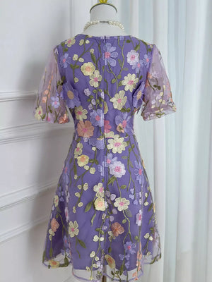 Purple floral embroidered mesh dress with short sleeves and a flared skirt.