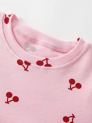 Children's blush pink short sleeve dress with cherry print and crew neck.