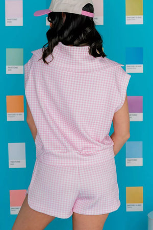 Pink gingham two-piece set with collared zip-detail top and drawstring shorts.
