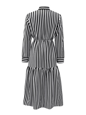 Notched long-sleeve midi dress in black and white stripe with a tiered skirt.