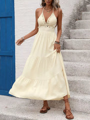 Chic cream halter neck maxi dress with tiered skirt and beaded trim.