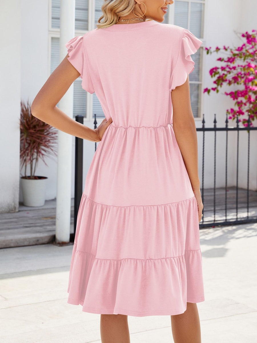 Blush pink midi dress with ruffled short sleeves, elastic waist, and tiered skirt.