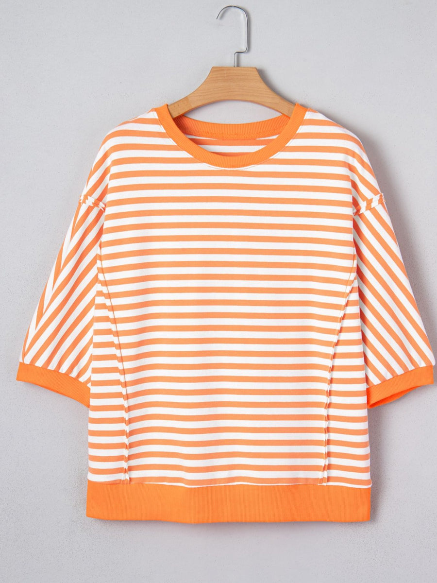 Oversized orange and white striped cotton t-shirt with 3/4 sleeves and crew neck.