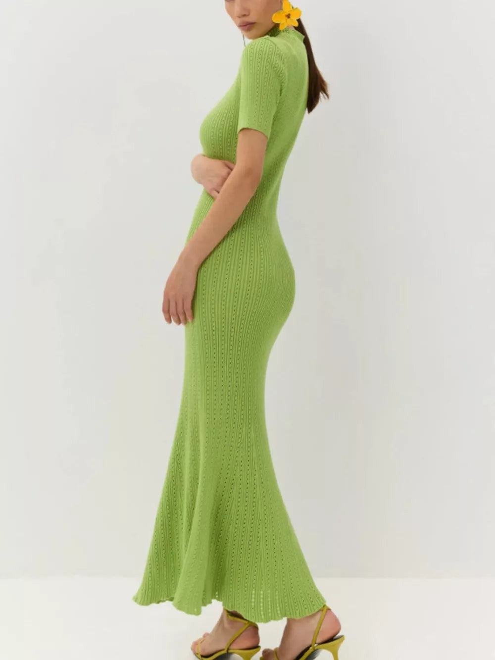 Lime green knitted mermaid dress with short sleeves and a tied neckline.