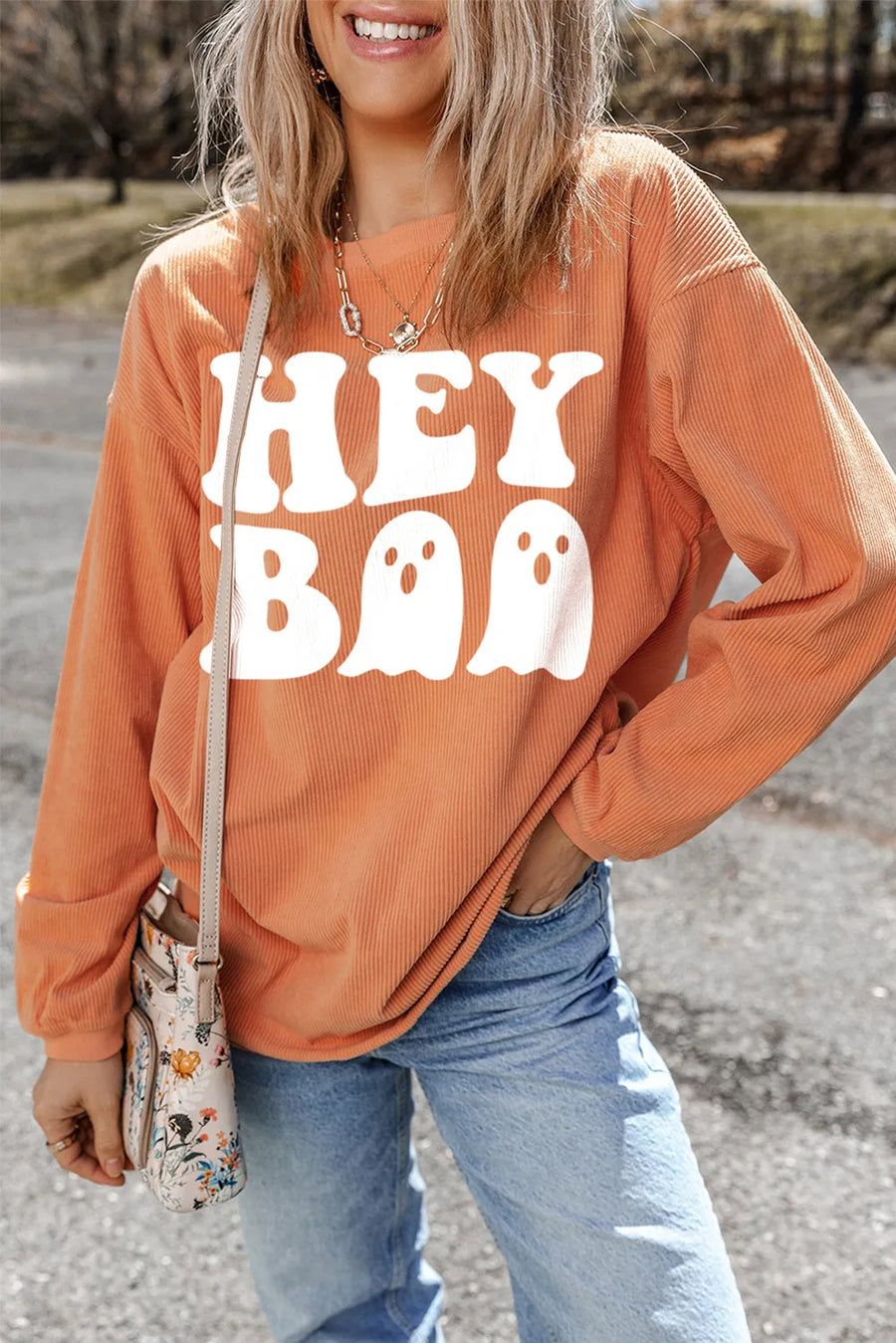 Orange corduroy sweatshirt with white "Hey Boo" ghost graphic.