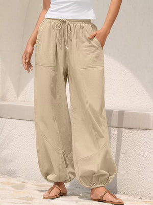 Khaki relaxed harem pants with drawstring and contrast stitching detail.