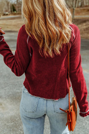 Burgundy waffle knit crewneck top with contrast stitching detail.