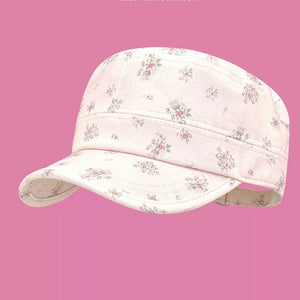 Cap with pink floral print on white fabric, adjustable strap detail