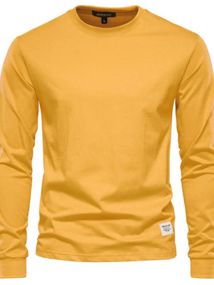 Gold long sleeve crewneck t-shirt with a small woven label on the hem.