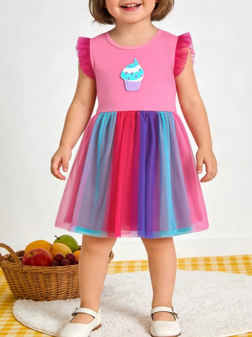 Pink cupcake graphic tulle dress with rainbow skirt and ruffled sleeves.