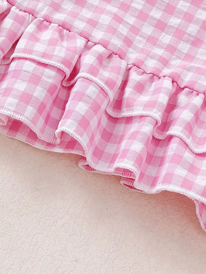 Pink gingham baby outfit with tiered ruffles and white trim detail