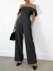 Dark gray off-shoulder top and wide-leg pants set with ruffled sleeves.