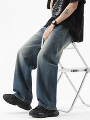 Vintage wash oversized wide-leg jeans in light blue with distressed details and a drawstring.