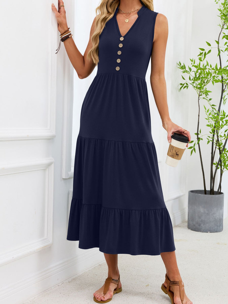 Navy tiered midi dress with notched V-neck and decorative buttons.