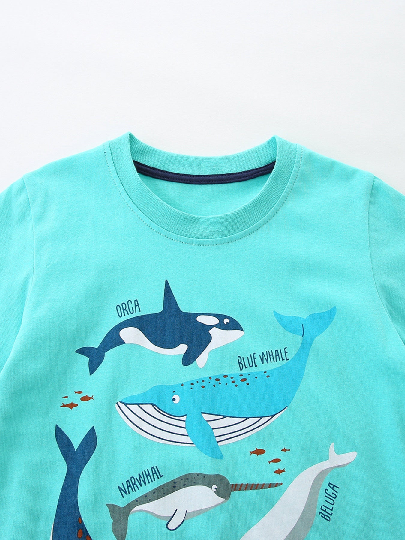 Turquoise cotton t-shirt with orca, blue whale, narwhal, and beluga whale print.