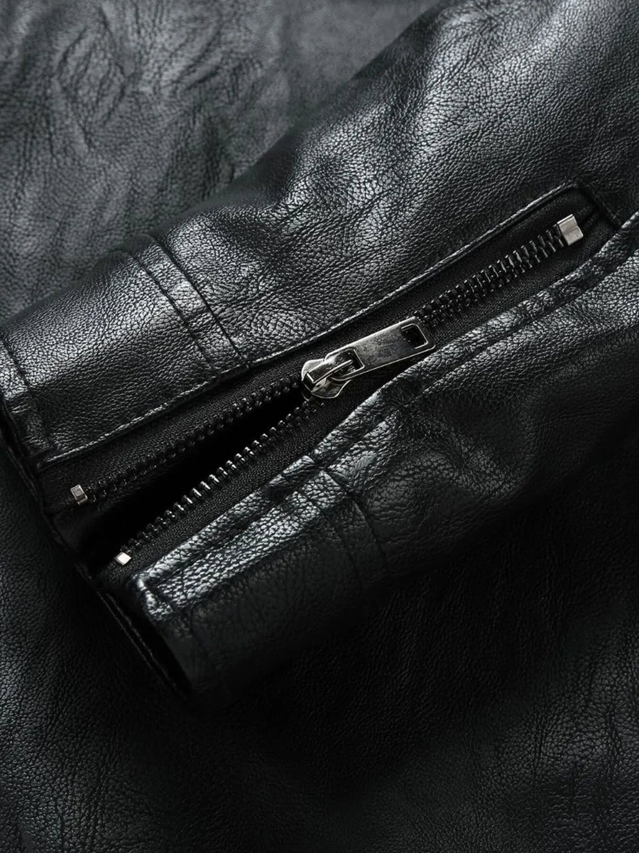 Black plus-size moto jacket with zip detail and textured faux leather.