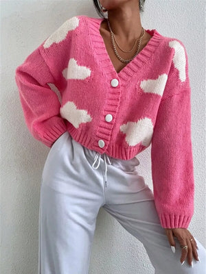 Hot pink acrylic button cardigan with white cloud pattern, V-neck, long sleeves.
