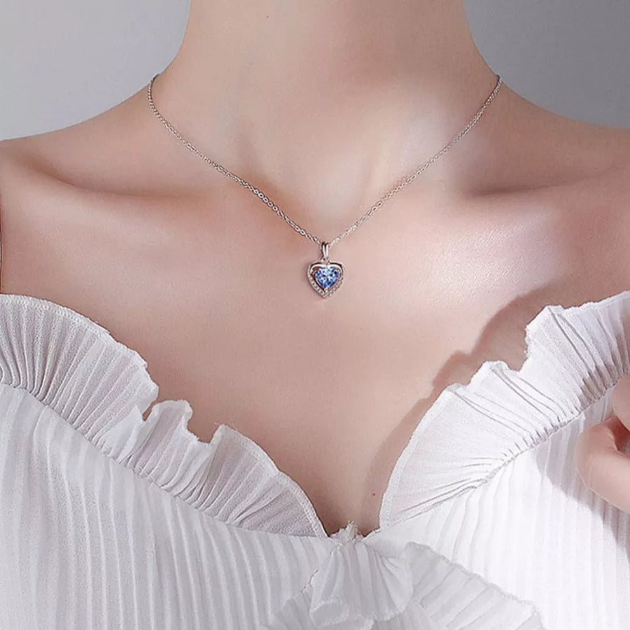 Elegant heart pendant necklace with blue zircon and silver chain.