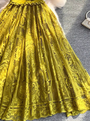 Yellow lace dress with intricate paisley pattern and ruffled waist detail.